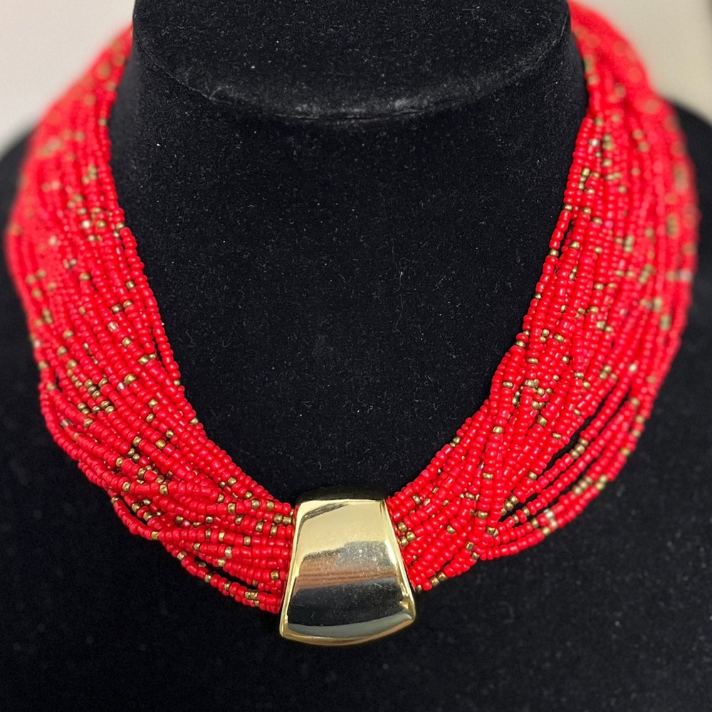 23 strand red seed bead necklace. 18-20”. Gold focal slide. NIP. Weighted…